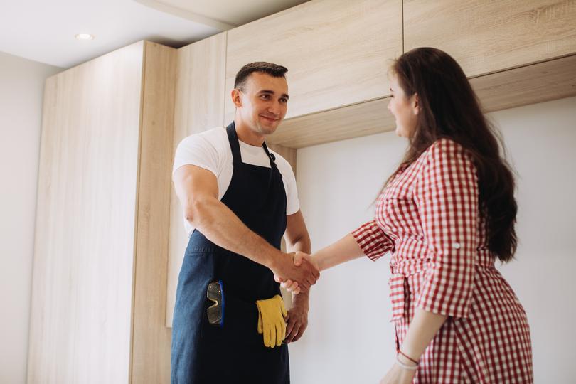 #1 seo-agency for home service contractors in Ealing  - maintenance-man-and-a-client-shaking-hands